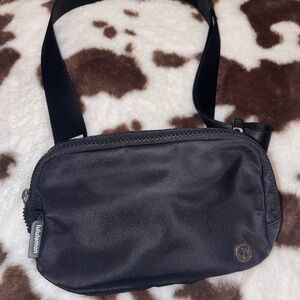 Black with lululemon logo everywhere belt bag